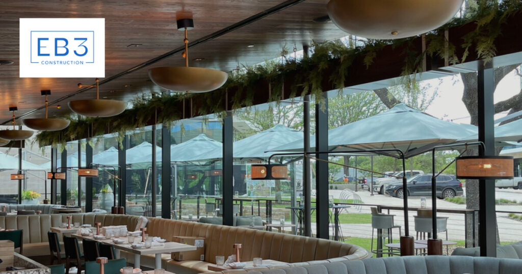 A modern restaurant interior with outdoor views and stylish lighting.