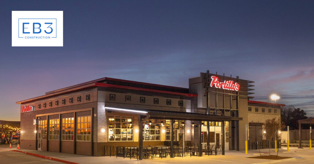 A restaurant with illuminated signage during twilight, featuring a modern exterior design.