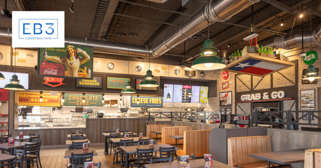 A retro-style diner interior with colorful signs and wooden seating.