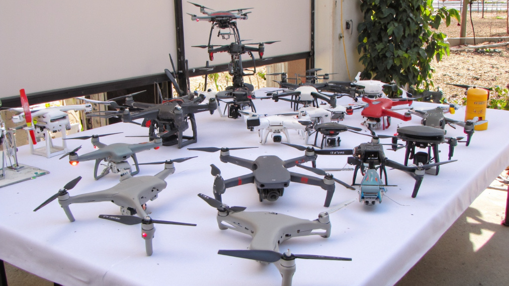 Different Drone Models on Display Array of different drone models on display table at construction office, ranging from small quadcopters to larger industrial drones