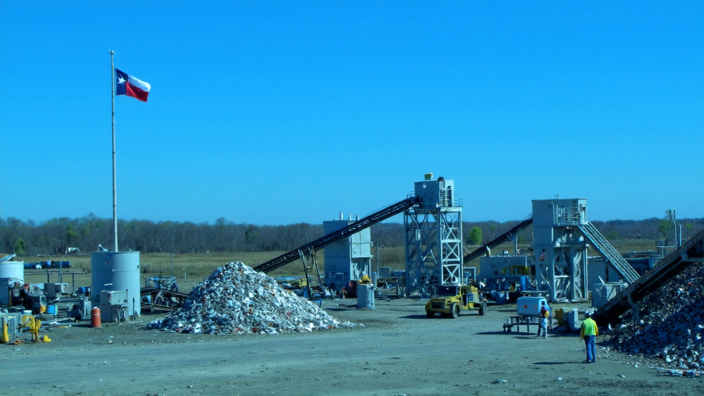 Modern Recycling Plant with Texas Flag Efficient modern recycling plant processing construction materials with Texas flag visible