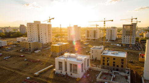 A modern construction site in Texas with a mix of residential and commercial buildings under development.