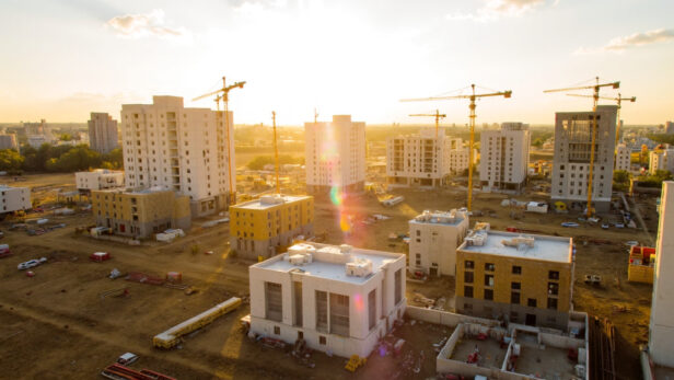 A modern construction site in Texas with a mix of residential and commercial buildings under development.