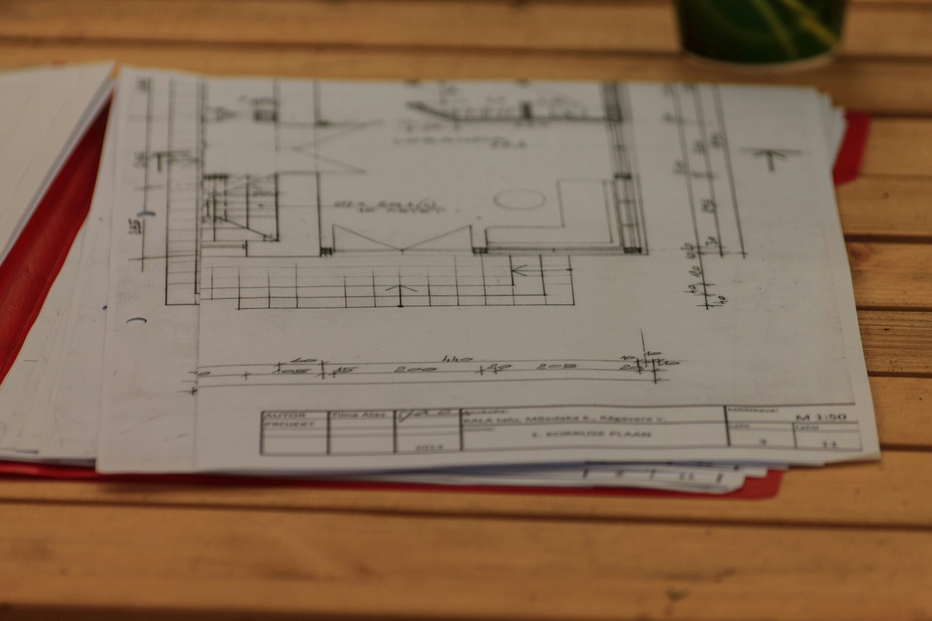 Architectural Plans and Designs A close-up of architectural plans on a wooden table.