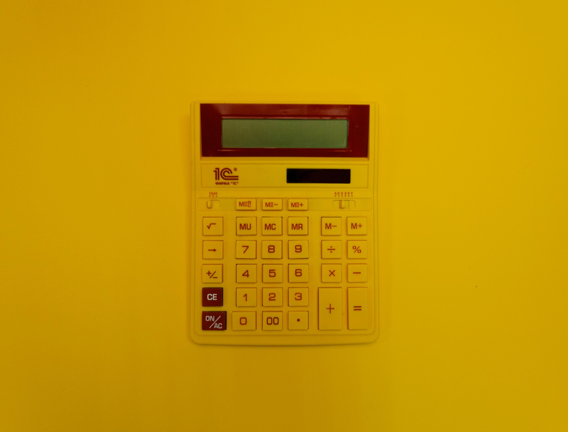 Bright Yellow Calculator A yellow calculator on a bright yellow background.