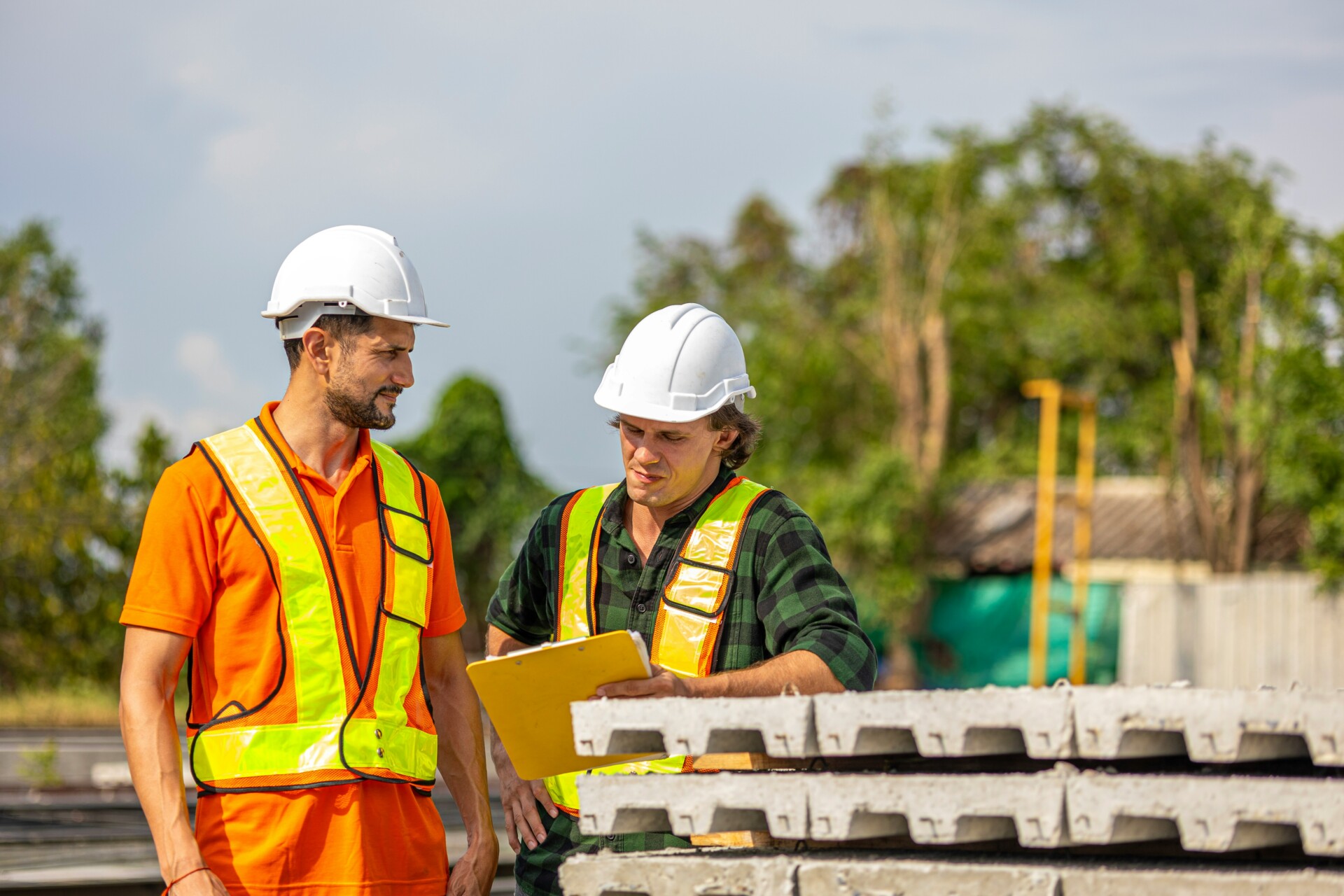 Collaboration on a Construction Site Two construction workers discussing plans on a building site