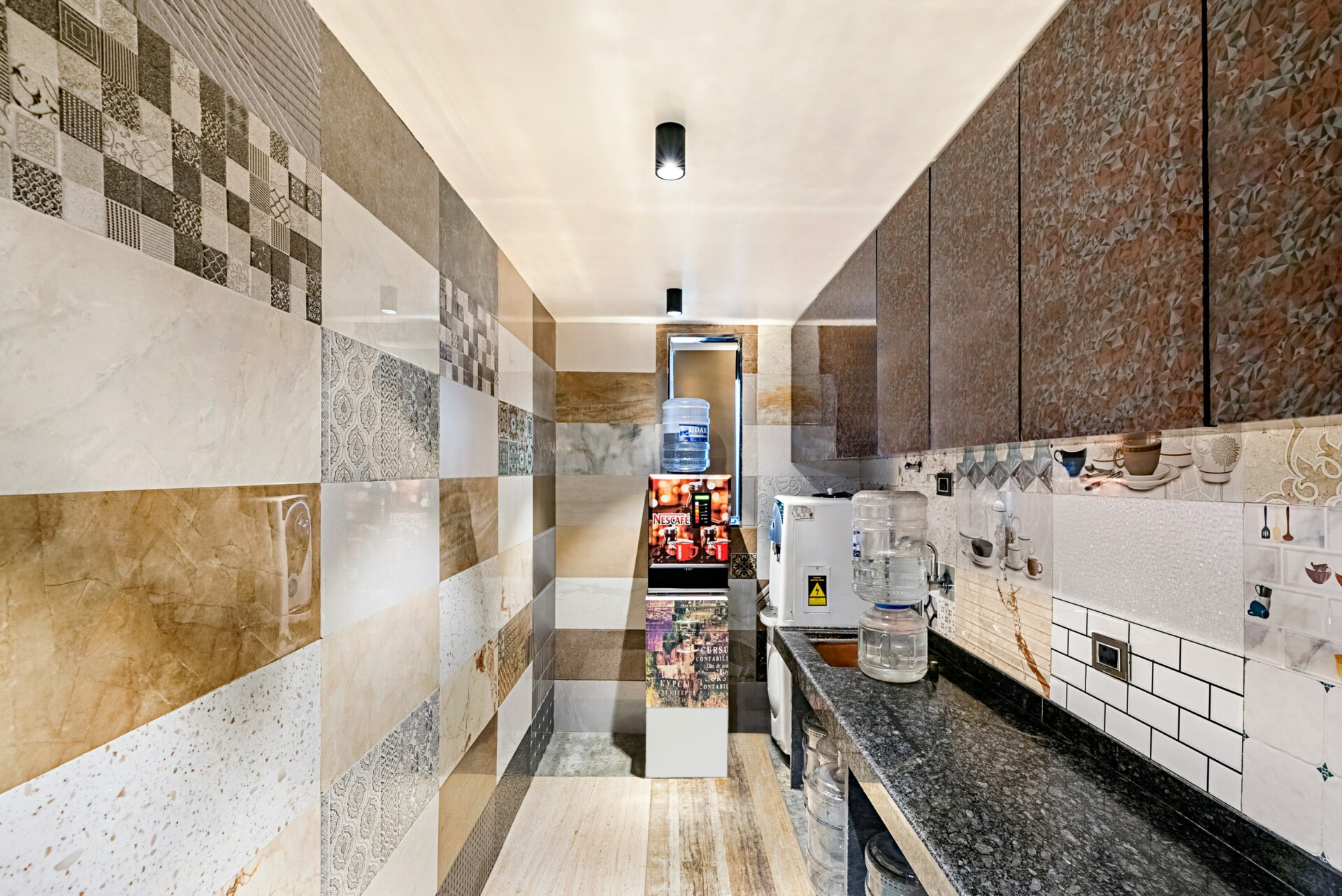 Stylish Modern Kitchen Interior A view of a modern kitchen interior featuring patterned tiles and water dispensers.
