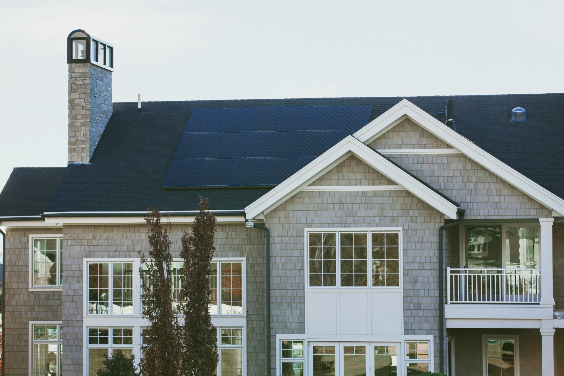 Modern Home with Solar Energy Solutions A modern house featuring solar panels on the roof, showcasing energy-efficient design.