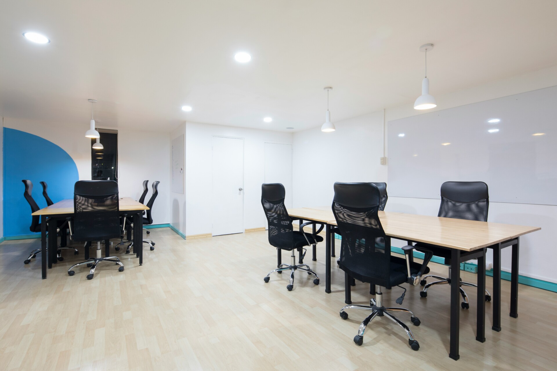 Contemporary Meeting Room Interior A modern meeting room with wooden tables and black office chairs