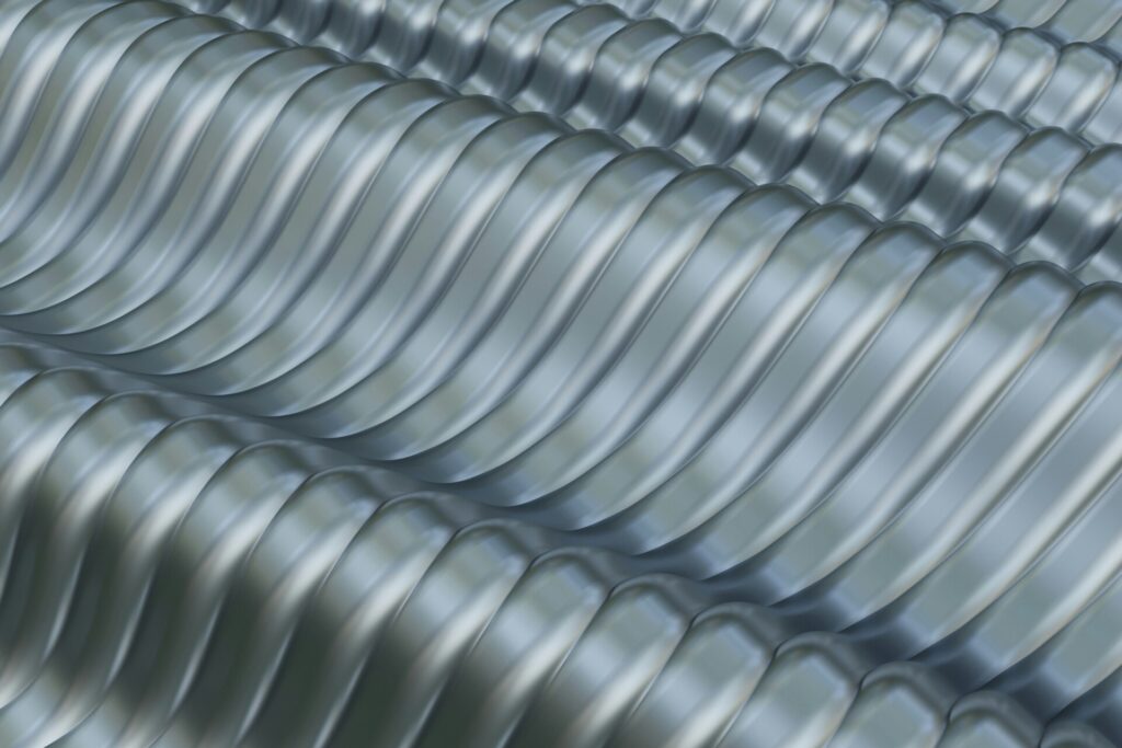 Close-up of shiny corrugated metal sheets with a wavy texture.