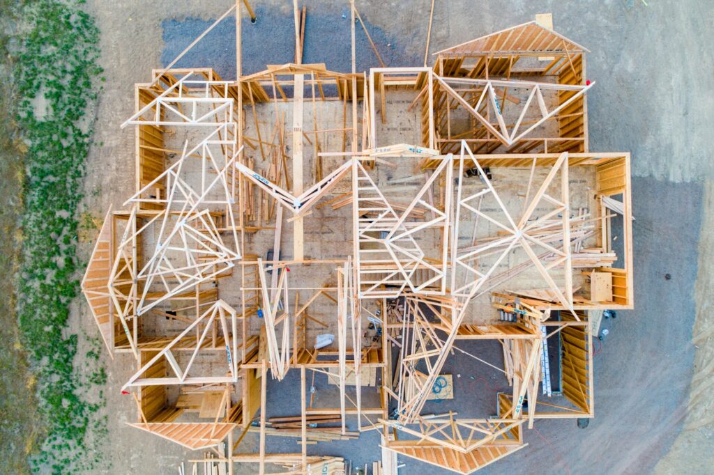 Aerial view of a wooden house frame under construction.