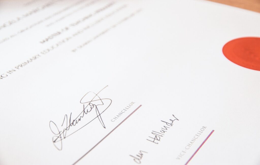 Close-up of a certificate featuring signatures and a red seal.