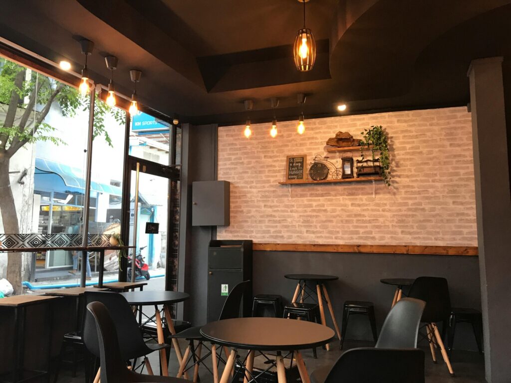 Cozy cafe interior with modern decor and warm lighting.