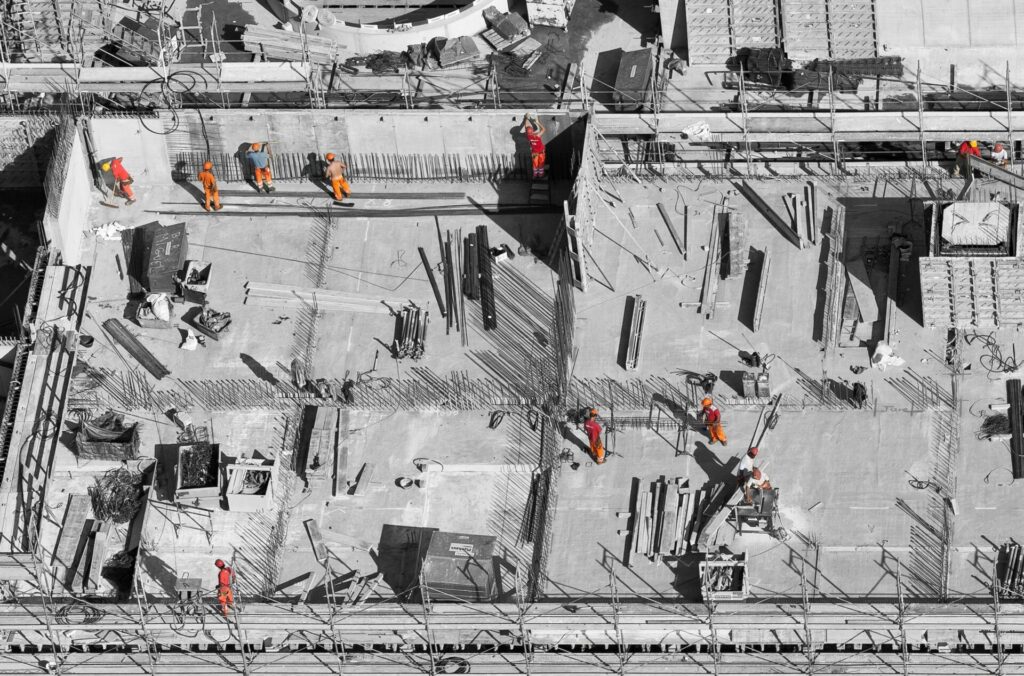 Aerial view of construction workers on a building site with scaffolding.