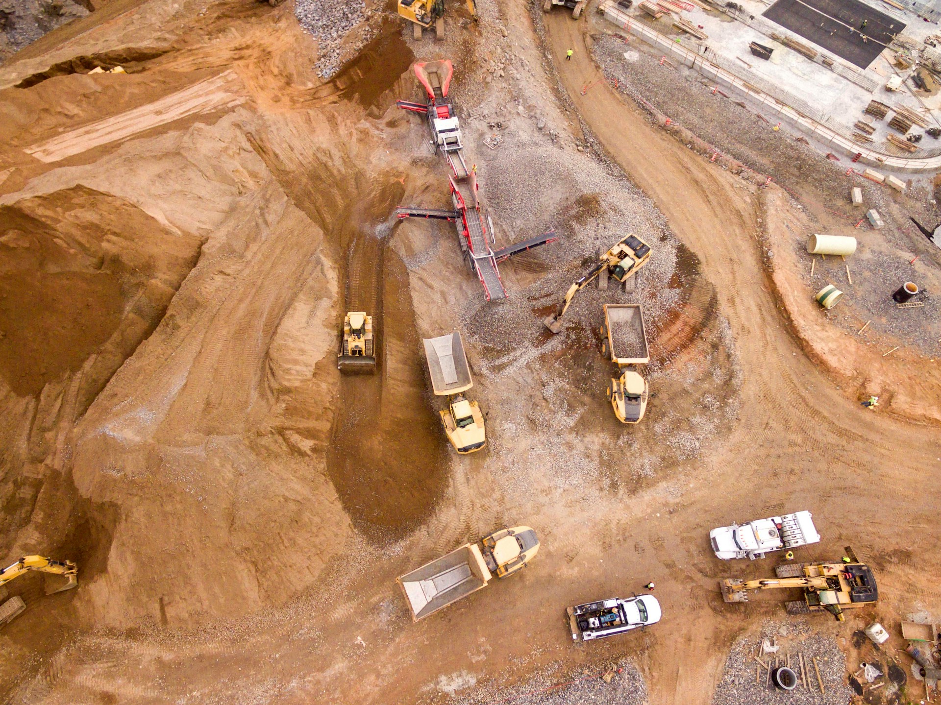 Aerial view of a busy construction site with vehicles and machinery in action.