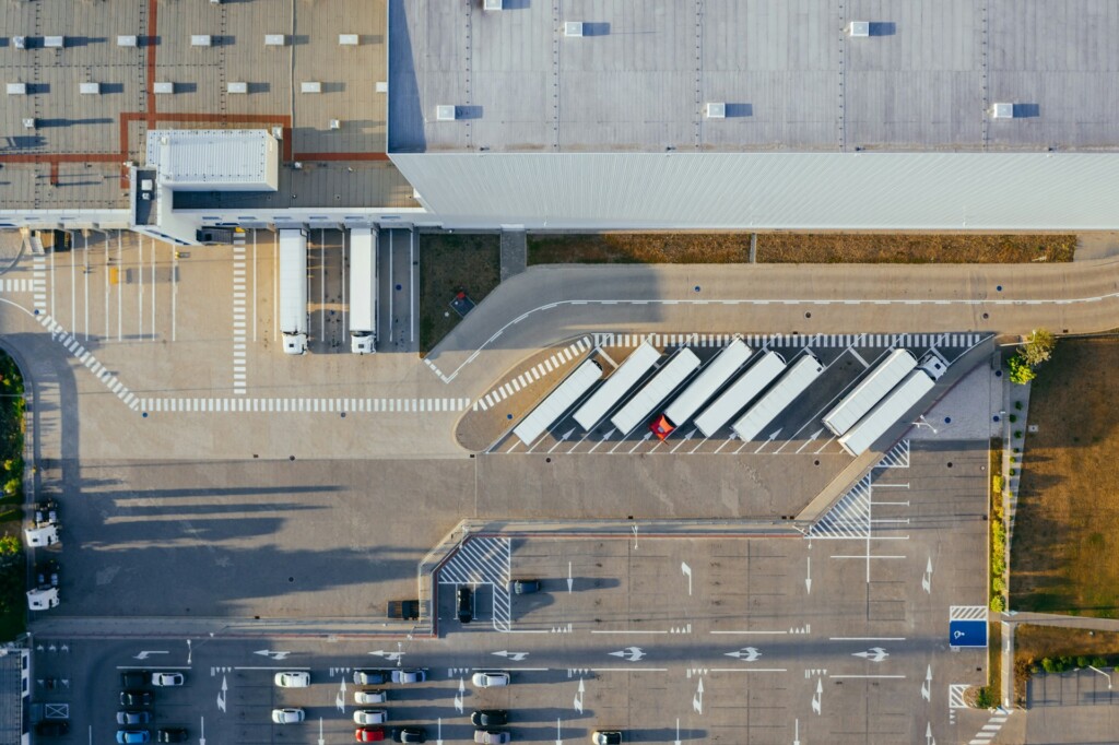 Aerial view of a warehouse loading dock with several parked trucks.