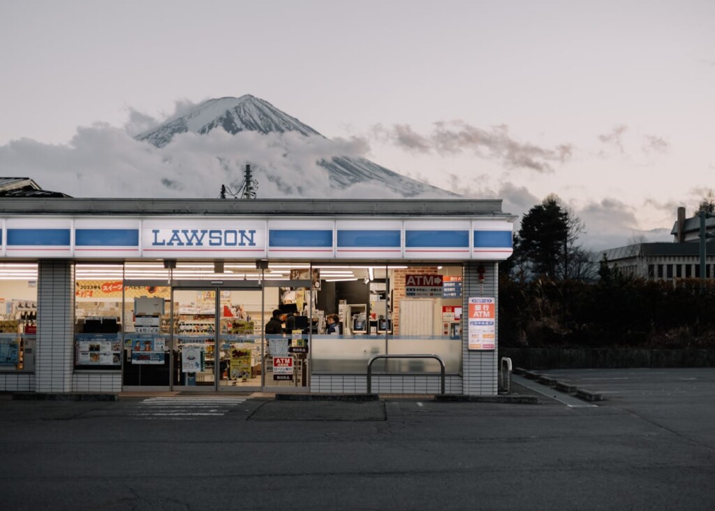 Convenience store with Mount Fuji in the background during the evening.