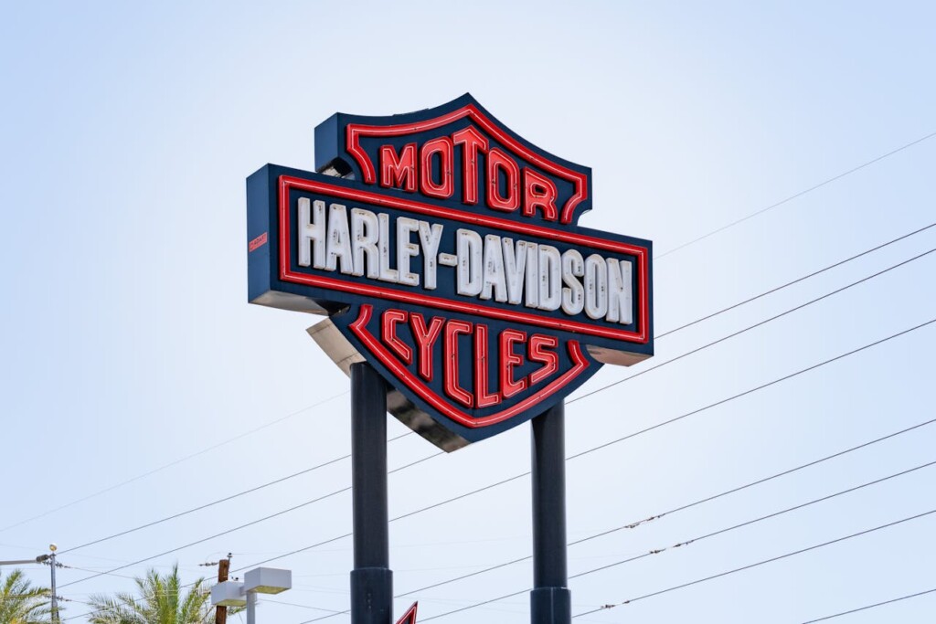 Harley-Davidson neon sign against a clear blue sky.