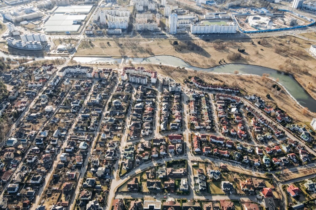 Aerial view of a suburban area with houses and buildings in a cityscape.