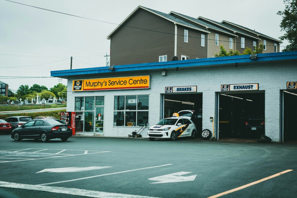 A car parked outside Murphy's Service Centre with service bays visible.