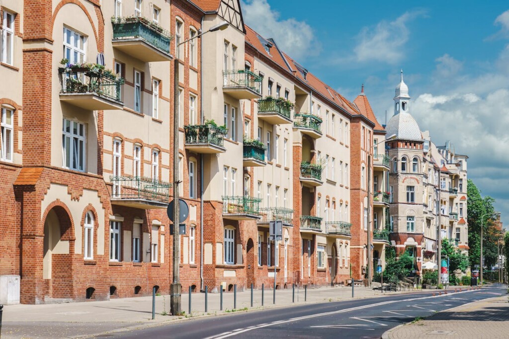 A row of traditional European apartment buildings with balconies on a sunny day.