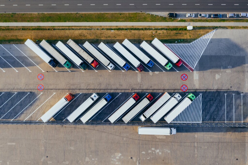 Aerial view of trucks parked diagonally in a large parking lot.